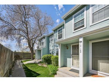 Charming, light-blue townhome with landscaped front yard and welcoming entrance at 12125 Bannock St # C, Westminster, CO 80234