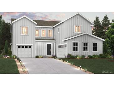 Charming two-story home with two-car garage, lovely landscaping and welcoming front porch at 13750 Emerald Lake St, Parker, CO 80138