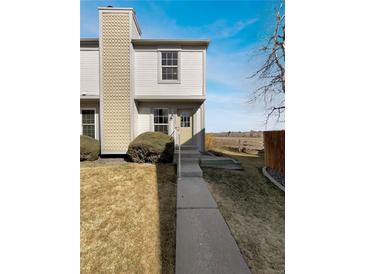 Charming townhome with a manicured front lawn and inviting entrance walkway on a sunny day at 1622 S Idalia Cir # G, Aurora, CO 80017