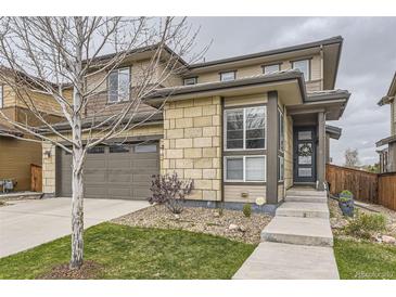 Charming two-story home featuring a two-car garage and stylish stone accents at 14315 Big Stone Dr, Parker, CO 80134