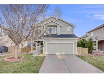 Charming two-story home with a well-maintained lawn and two car garage at 11223 Jansen St, Parker, CO 80134