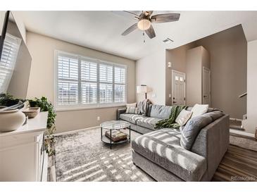 Inviting living room with large windows and comfortable seating at 1817 S Buchanan Cir, Aurora, CO 80018