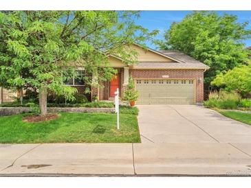 Charming single-Gathering home with brick facade, green lawn, mature trees, and a two-car garage at 6731 E 128Th Pl, Thornton, CO 80602