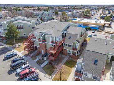 Aerial view of multi-Gathering building with patios, stairs, and parking lot at 970 S Dawson Way # 15, Aurora, CO 80012