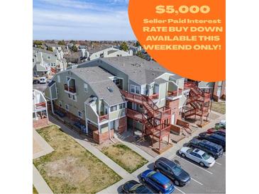 Exterior view of the property featuring well-maintained landscaping and ample parking spaces in a desirable location at 970 S Dawson Way # 15, Aurora, CO 80012
