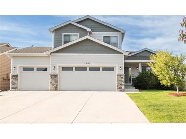 Inviting two-story home with a three-car garage and a well-manicured front yard at 1507 Alpine Ave, Berthoud, CO 80513
