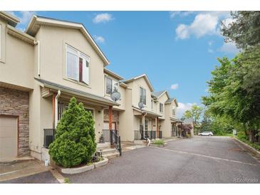 Inviting townhouse exterior showcasing a well-maintained facade and private entrances, nestled in a friendly community at 6973 W Louisiana Ave # E, Denver, CO 80232
