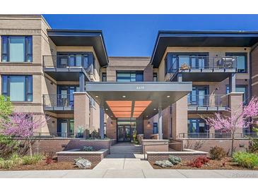 Beautiful condominium entrance featuring brick facade, modern architectural design and well maintained landscape at 6619 E Lowry Blvd # 112, Denver, CO 80230