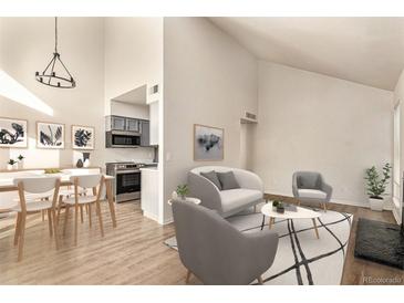 Bright living room features a fireplace and access to a balcony at 3549 S Fairplay Way # 10, Aurora, CO 80014