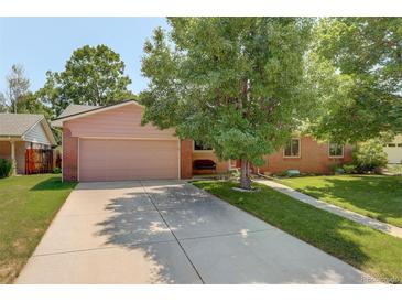 Charming single-story home with a well-manicured front yard and a two-car garage at 2920 S York St, Denver, CO 80210