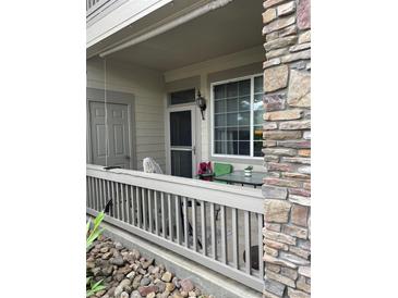 Cozy covered patio with stone accents and outdoor seating, perfect for relaxing at 10457 W Hampden Ave # 104, Lakewood, CO 80227