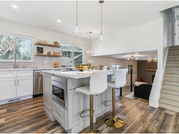 Modern kitchen with stainless steel appliances and an island at 7649 E Amherst Ave, Denver, CO 80231