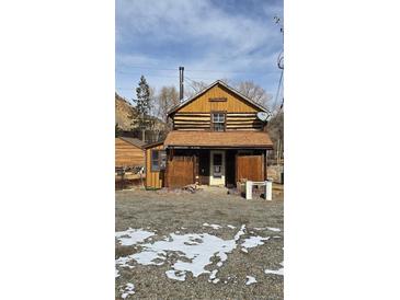 Charming two-story home with a rustic exterior and a mix of log and wood siding at 605 Argentine St, Georgetown, CO 80444