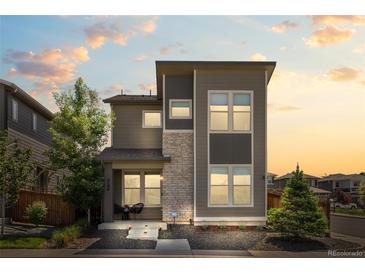 Modern two-story home with stone accents, landscaped front yard, and a welcoming entrance at 6700 Clay St, Denver, CO 80221