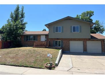 Charming two-story home with brick and siding, two car garage, and landscaped front yard at 12252 Elmendorf Pl, Denver, CO 80239