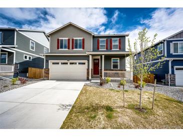 Charming two-story home with gray siding, red shutters, and a well-manicured front lawn at 17955 Sky Pilot Ave, Parker, CO 80134