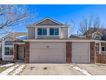 Two-story house with a three-car garage and brick facade at 1365 Mulberry Ln, Highlands Ranch, CO 80129