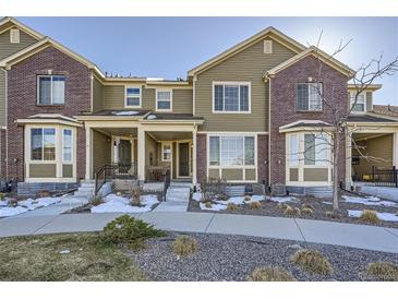 Charming two-story townhome with a combination of brick and siding and well-maintained front yard at 6268 Pike Ct # D, Arvada, CO 80403