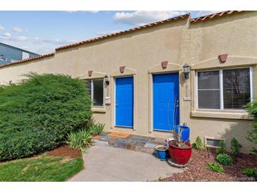 Charming townhouse exterior with blue doors, terracotta roof, and landscaped entryway at 1804 Grove St, Denver, CO 80204