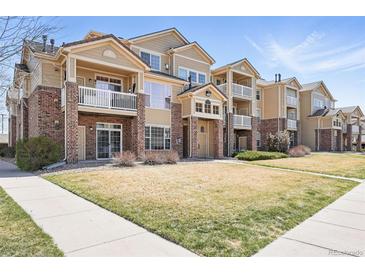 Attractive condo building featuring brick accents, private balconies, and well-maintained landscaping at 5763 N Gibralter Way # 2-108, Aurora, CO 80019