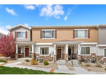 Inviting townhome featuring charming exteriors, landscaped front yard, and private entrances at 871 E 98Th Ave # 1402, Thornton, CO 80229