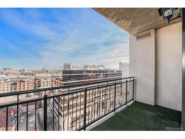 City views from the balcony with black railings and an artificial turf floor covering at 1827 N Grant St # 1104, Denver, CO 80203