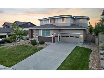 Beautiful two-story home with a well-manicured lawn, charming curb appeal, and a two car garage at 4145 Manorbrier Cir, Castle Rock, CO 80104