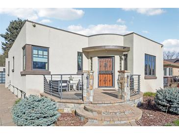 Charming home featuring a decorative security door, stone accents, and inviting front patio area at 621 Kearney St, Denver, CO 80220