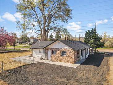 Charming home featuring stone accents, white siding, a new roof, and landscaping at 16130 Mt Vernon Rd, Golden, CO 80401