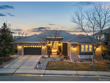 Charming single-story home boasting stone accents, gray roof, and a two-car garage at 2988 Rockbridge Dr, Highlands Ranch, CO 80129