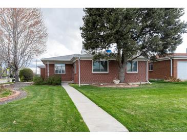 Charming brick home with a well-manicured front lawn and inviting walkway at 5582 E Colorado Ave, Denver, CO 80222