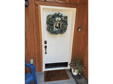 Inviting front door with festive wreath, keyless entry and decorative potted flowers at 21221 Colorado 103, Idaho Springs, CO 80452