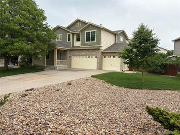 Charming two-story home featuring a three-car garage, well-kept lawn, and mature trees in a suburban setting at 14642 Williams St, Thornton, CO 80602