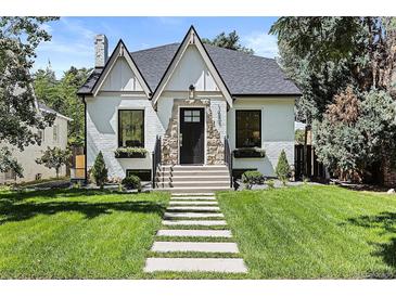Charming white brick home with a black roof and manicured lawn at 1655 S Marion, Denver, CO 80210