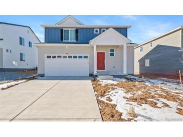 Two-story home with blue siding, red door, and a two-car garage at 3987 N Riviera Ct, Aurora, CO 80019