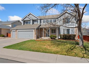 Inviting two-story home featuring a manicured lawn, attached two-car garage, and neutral color palette at 7313 W 98Th Pl, Broomfield, CO 80021