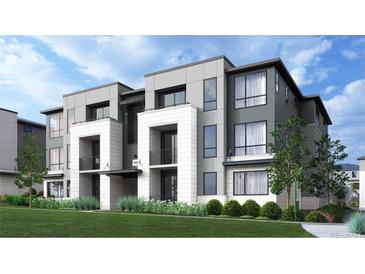 Modern townhome showcasing sleek lines, balconies, and a well-manicured lawn, capturing contemporary elegance at 11940 Soprano Cir # 201, Lone Tree, CO 80134