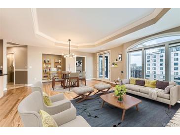 Bright living room features a dining area, hardwood floors, and balcony access at 1827 N Grant St # 800, Denver, CO 80203