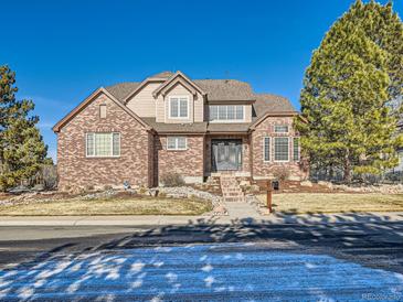 Charming brick two-story home with a landscaped front yard and grand entrance at 18971 E Pinewood Dr, Aurora, CO 80016