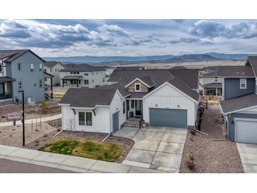 Beautiful single Gathering home with a two-car garage, nicely manicured yard, and mountain views at 4797 Saddle Iron Rd, Castle Rock, CO 80104