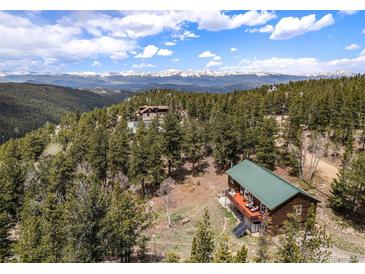 Secluded mountain home with green roof, solar panels, and a large deck overlooking the mountains at 72 Rudi W Ln, Golden, CO 80403