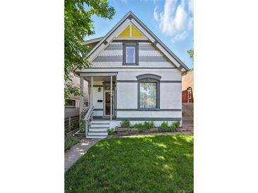 Charming two-story home with a well-manicured front yard and inviting porch at 3170 W 29Th Ave, Denver, CO 80211