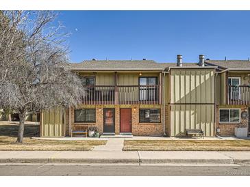 Two-story townhome featuring balconies, brick accents, and a well-kept front yard at 492 Vance St, Lakewood, CO 80226