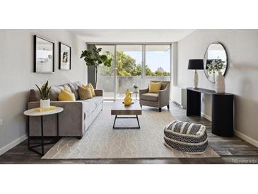 Bright living room with stylish decor, large windows, and a cozy seating area perfect for relaxation at 909 N Logan St # 6K, Denver, CO 80203