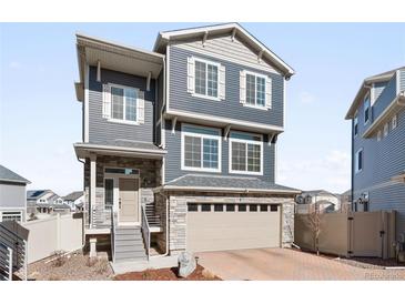 Charming two-story home featuring stone accents, a two-car garage, and a well-maintained front yard with great curb appeal at 21925 E 44Th Pl, Aurora, CO 80019