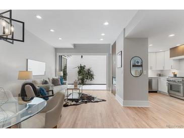 Bright living room with a modern design, fireplace, and view of the outdoor patio at 434 Clayton St, Denver, CO 80206