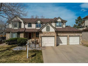 Charming two-story home with brick accents and a three car garage at 17085 E Dorado Cir, Centennial, CO 80015