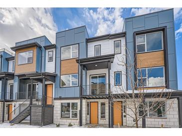 Modern townhome with blue and white exterior, orange door, and balcony at 2570 Josephine Way, Superior, CO 80027