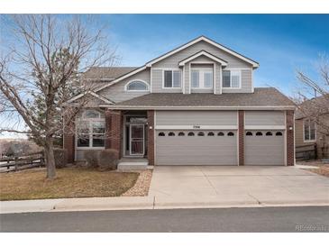 Charming two-story home with a three-car garage and a combination of siding and brick accents at 7506 Chipmunk Pl, Littleton, CO 80125