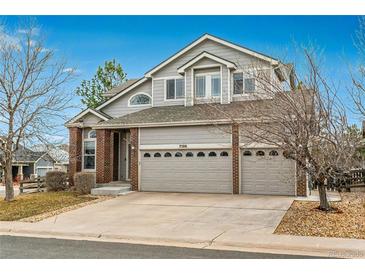 Charming two-story home with a three-car garage and a well-manicured front yard at 7506 Chipmunk Pl, Littleton, CO 80125